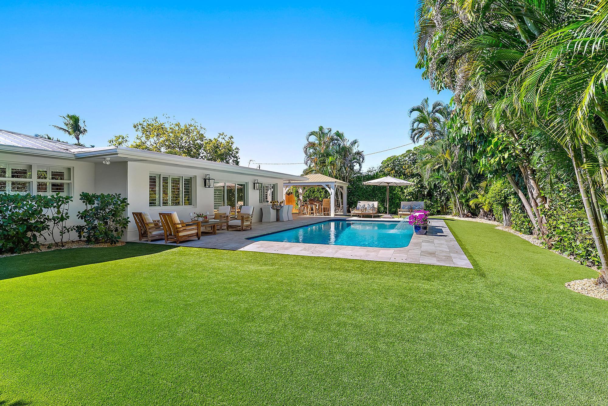 4967 Bimini Road Tequesta, FL 33469 - Photo 16 of 36 a view of an house with swimming pool and porch