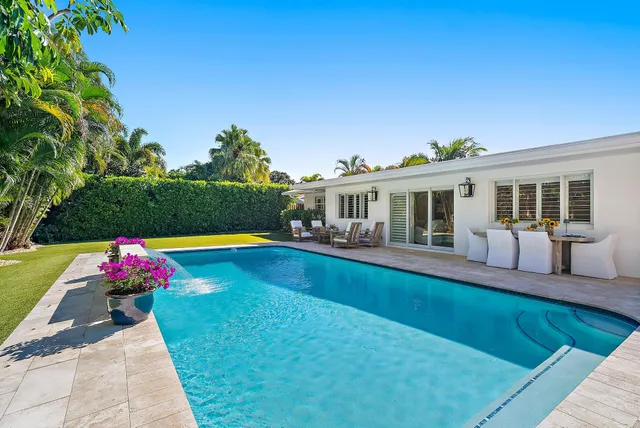 a view of house with swimming pool outdoor seating