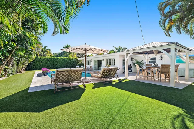 a view of a house with backyard porch and sitting area