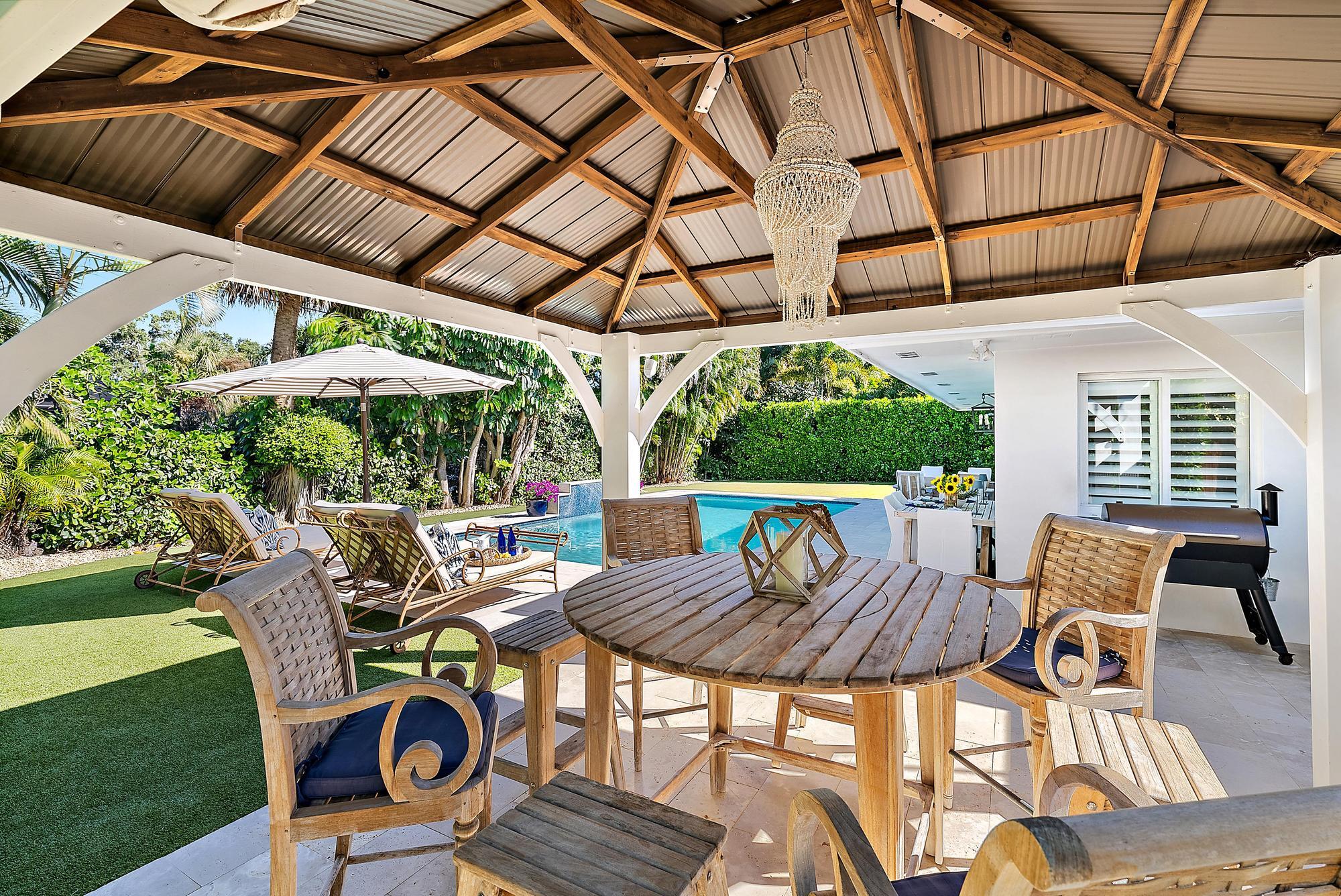 4967 Bimini Road Tequesta, FL 33469 - Photo 20 of 36 a patio with a patio table and chairs