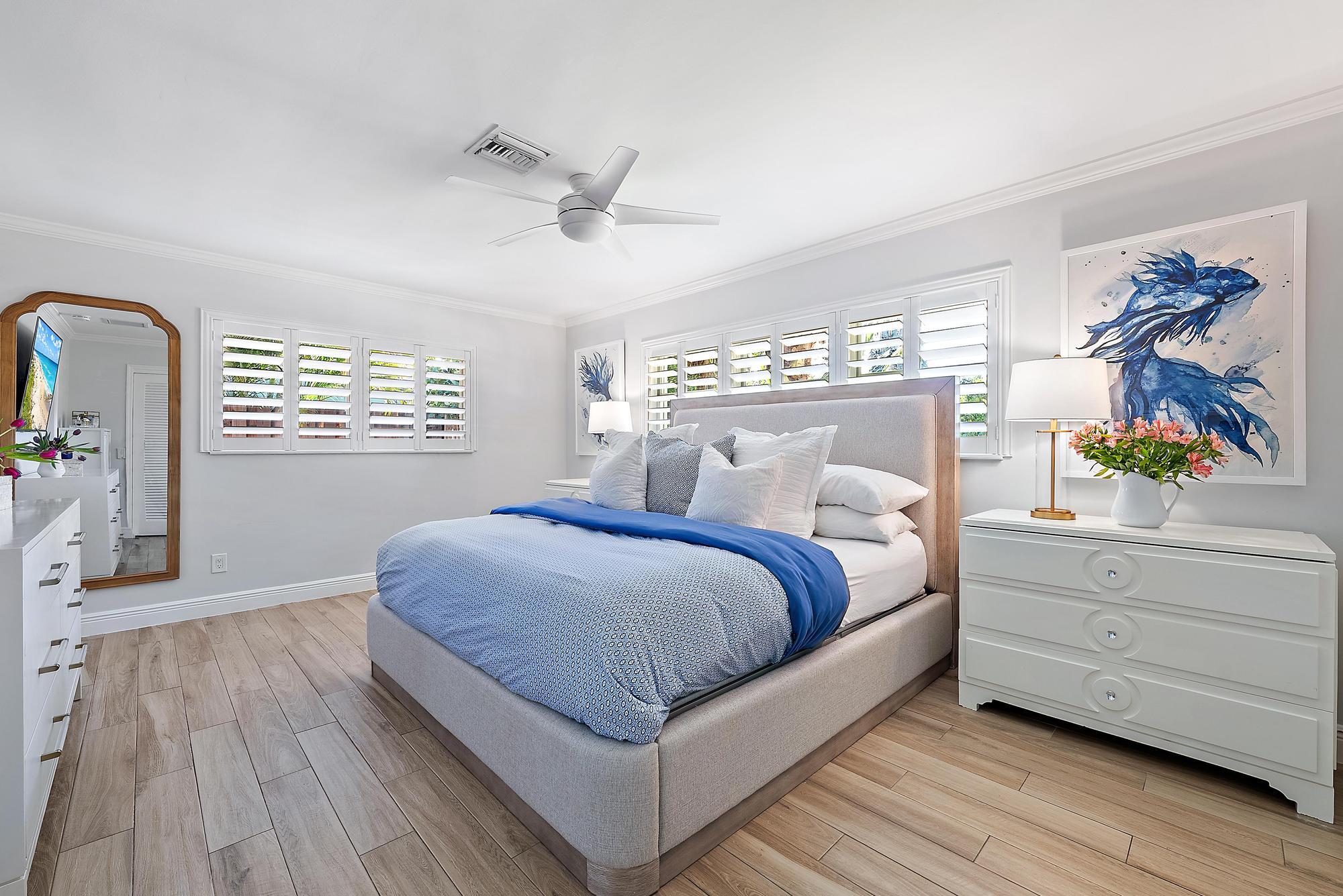 4967 Bimini Road Tequesta, FL 33469 - Photo 24 of 36 a bedroom with a bed and a dresser