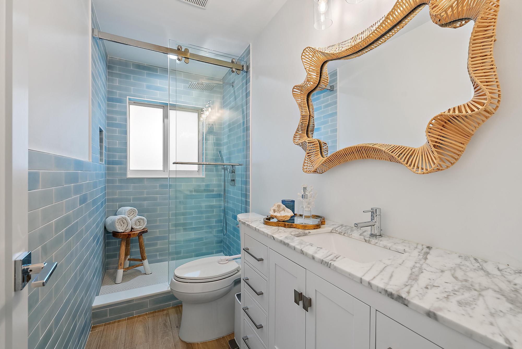 4967 Bimini Road Tequesta, FL 33469 - Photo 28 of 36 a bathroom with a granite countertop sink mirror vanity and toilet