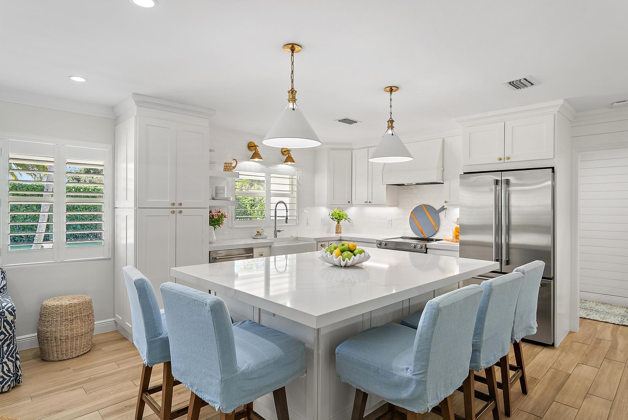4967 Bimini Road Tequesta, FL 33469 - Photo 7 of 36 a view of a dining room and livingroom with furniture wooden floor a chandelier