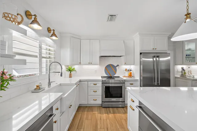 a kitchen with a sink cabinets and stainless steel appliances