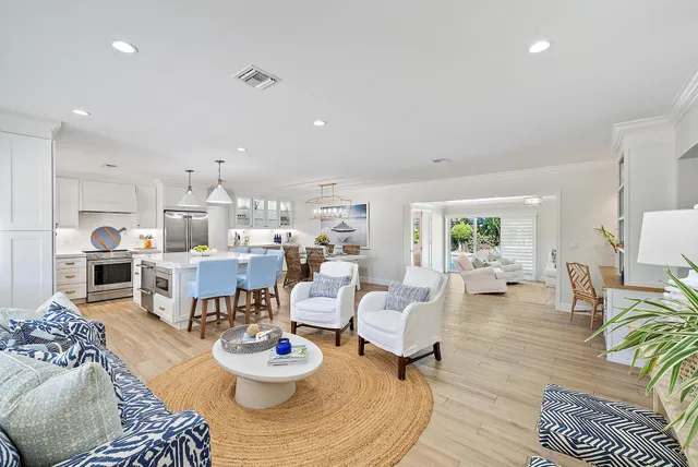 a living room with furniture kitchen view and a table