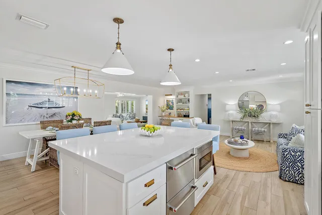 a view of a kitchen area with furniture and wooden floor