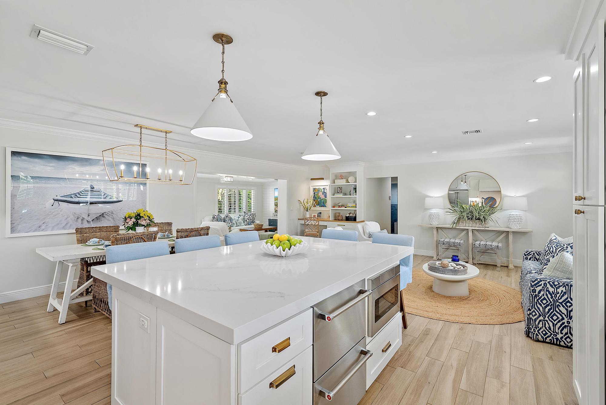 4967 Bimini Road Tequesta, FL 33469 - Photo 10 of 36 a view of a kitchen area with furniture and wooden floor