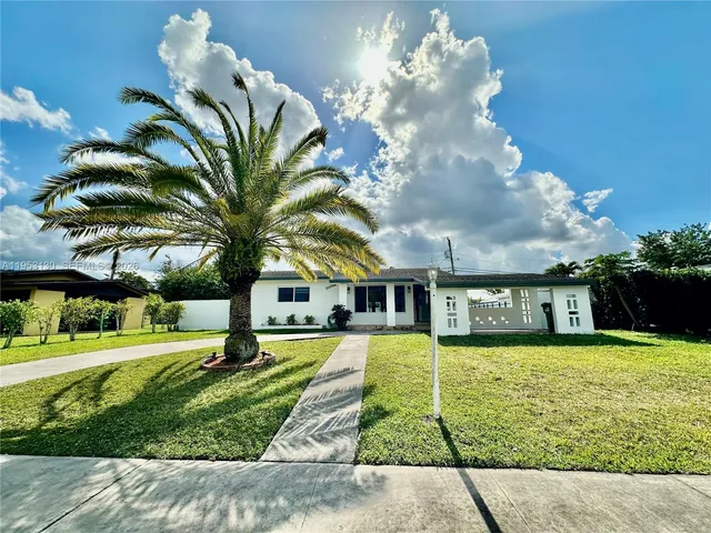 a view of a house with a swimming pool and a yard