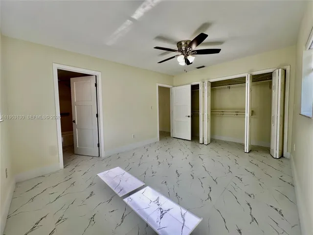 a bathroom with a granite countertop sink mirror toilet and bathtub