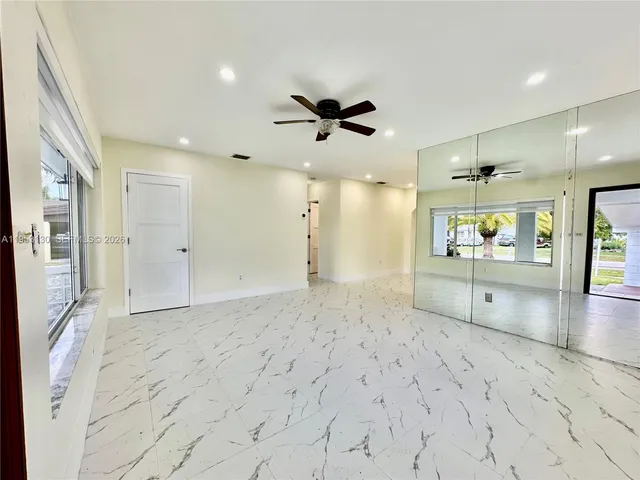 a view of a kitchen with a sink and a refrigerator