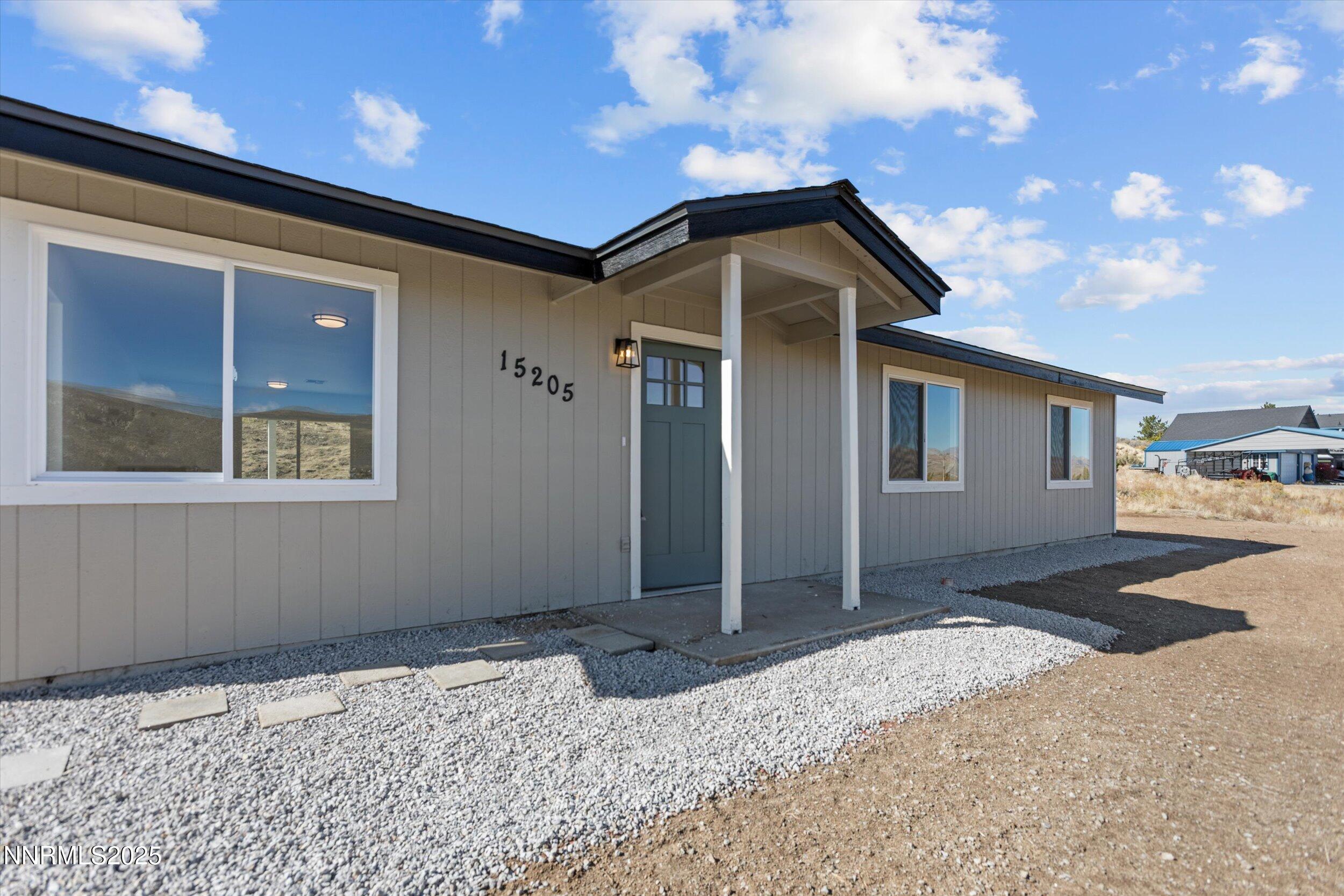 15205 North Red Rock Road Reno, NV 89508 - Photo 3 of 23 a front view of a house with a yard