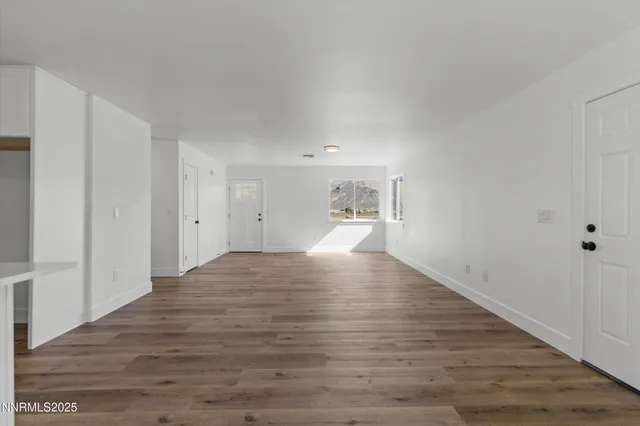 a bedroom with a large bed and a potted plant
