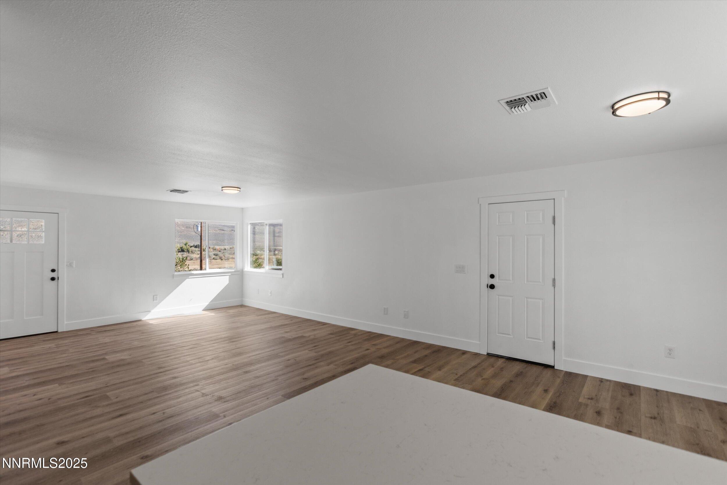 15205 North Red Rock Road Reno, NV 89508 - Photo 9 of 23 a view of empty room with wooden floor