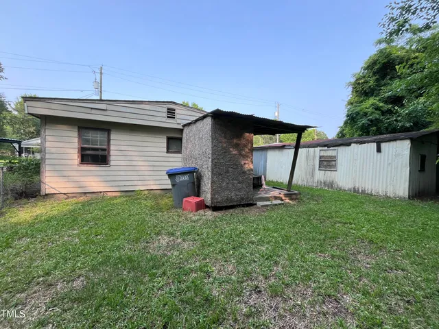 a view of a backyard with large trees