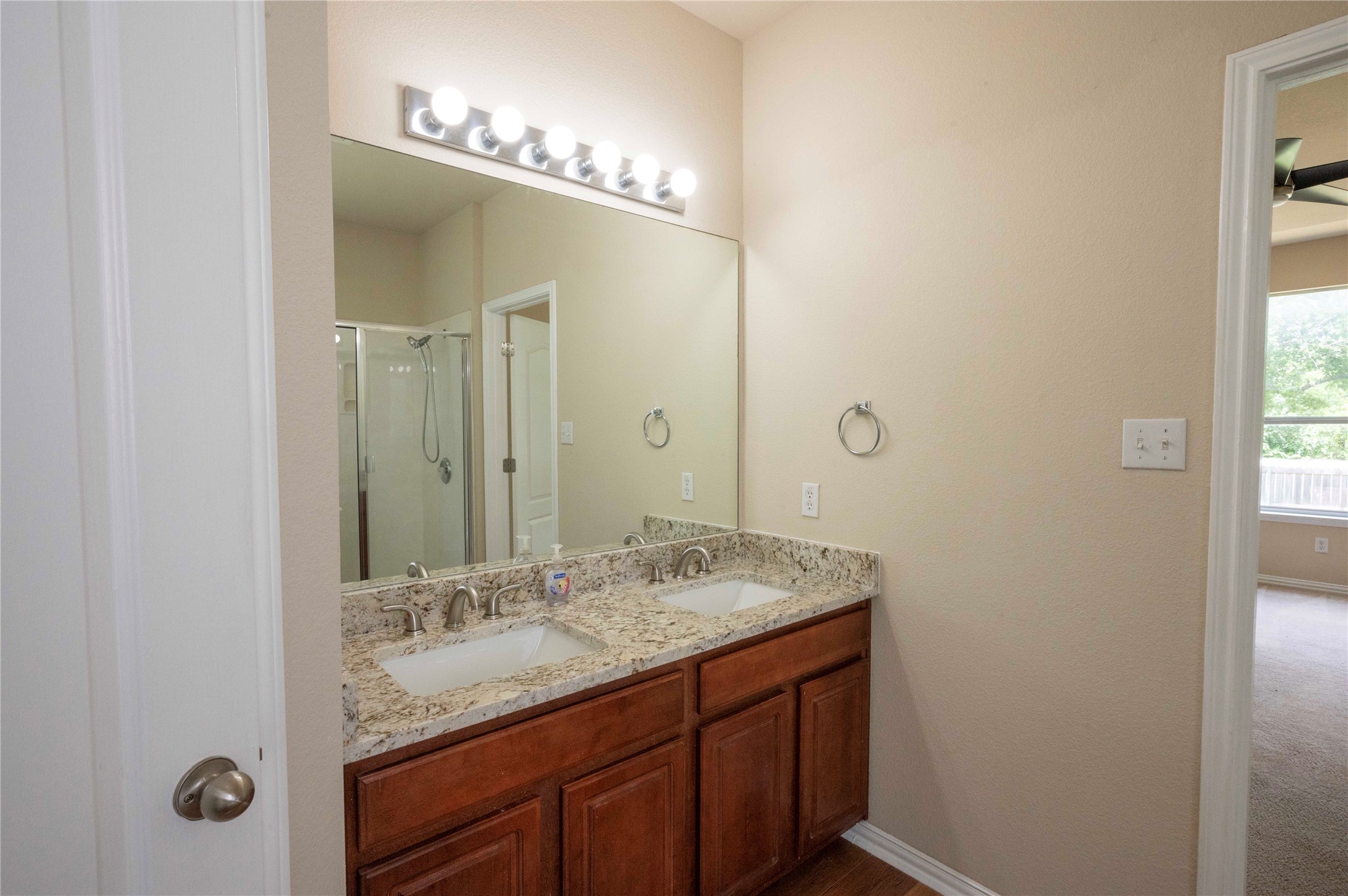 2070 Intrepid Drive Buda, TX 78610 - Photo 14 of 31 Double vanity with granite counters and a spacious mirror creates a functional bathroom.