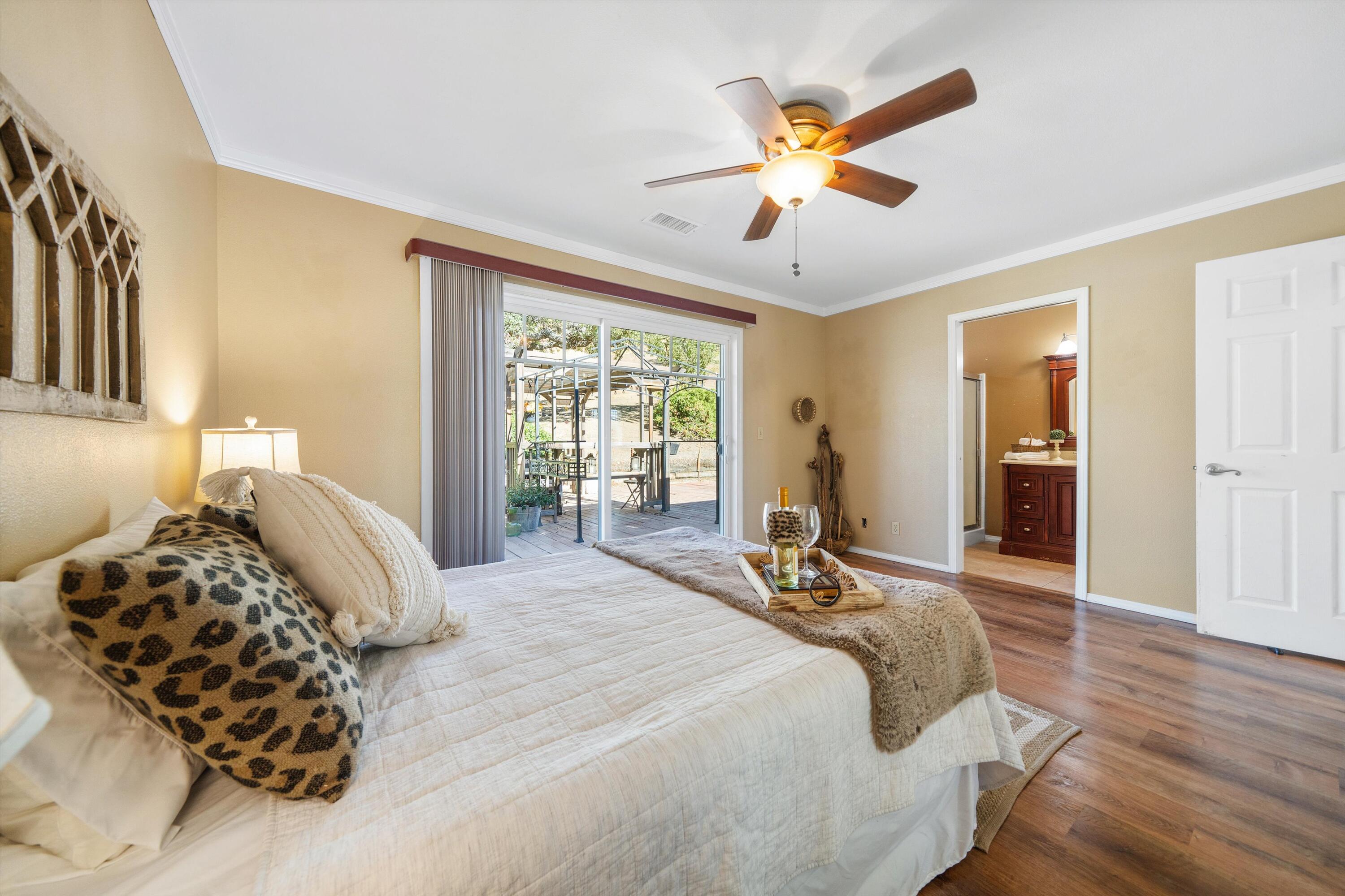 25801 Cumberland Road Tehachapi, CA 93561 - Photo 14 of 35 a bedroom with a bed and wooden floor