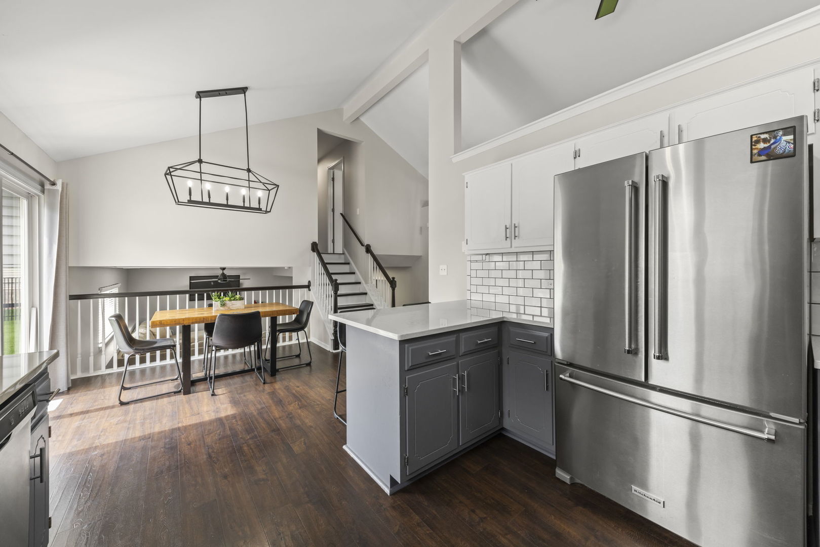 16505 Timberview Drive Plainfield, IL 60586 - Photo 11 of 29 a kitchen with stainless steel appliances granite countertop a refrigerator a sink dishwasher a stove and a dining table with wooden floor