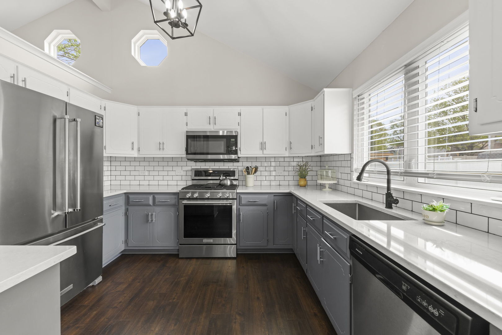 16505 Timberview Drive Plainfield, IL 60586 - Photo 9 of 29 a kitchen with stainless steel appliances granite countertop a sink a stove a refrigerator cabinets and a window