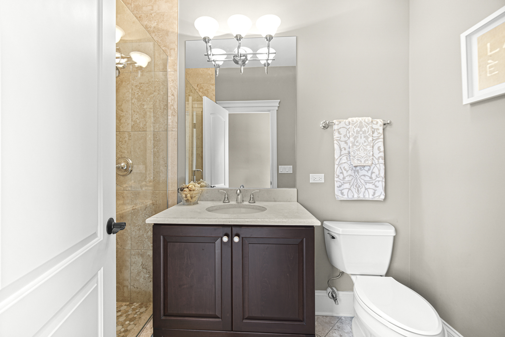 915 Forestview Road Addison, IL 60101 - Photo 17 of 49 a bathroom with a granite countertop toilet sink and mirror