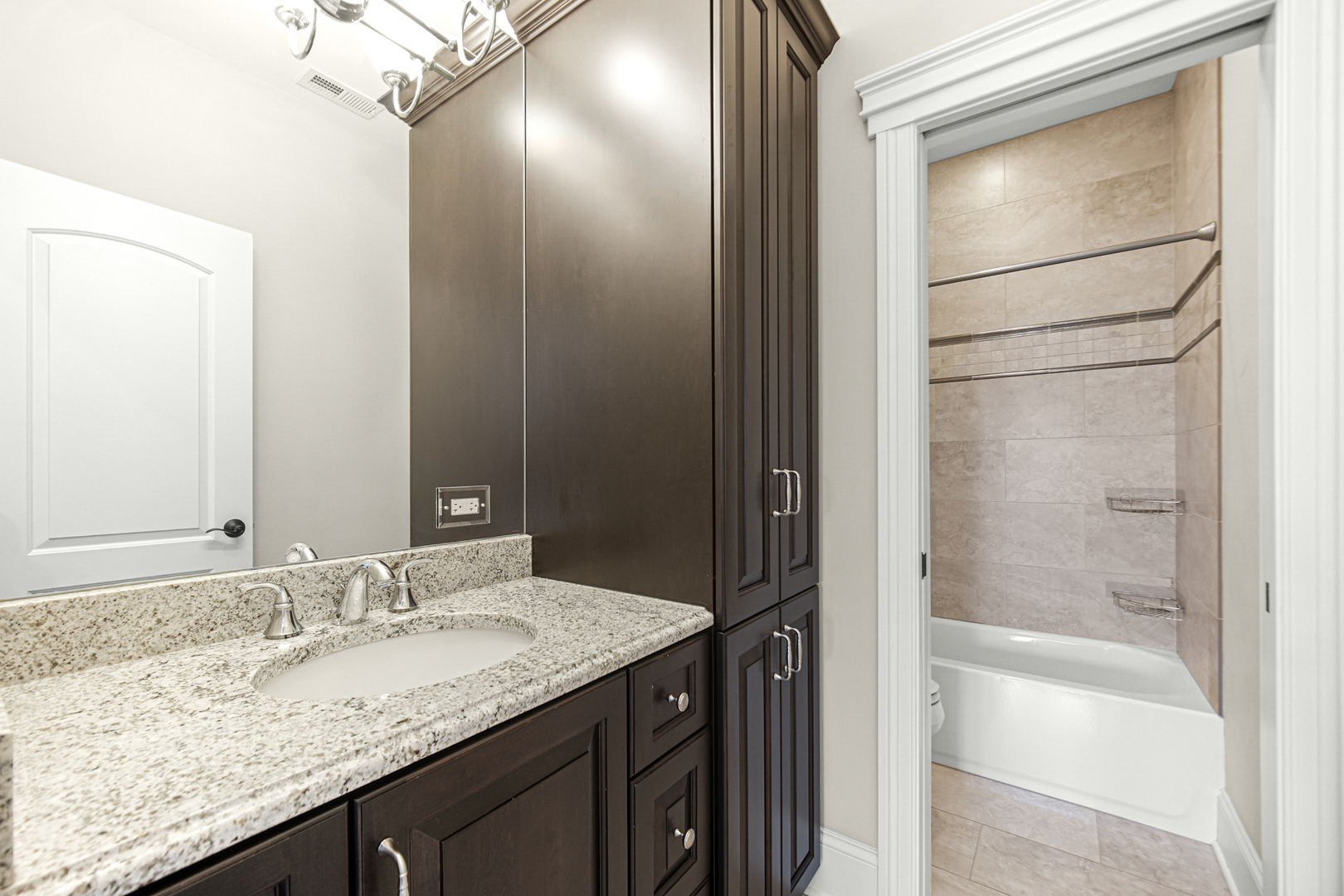 915 Forestview Road Addison, IL 60101 - Photo 21 of 49 a bathroom with a granite countertop sink and a mirror