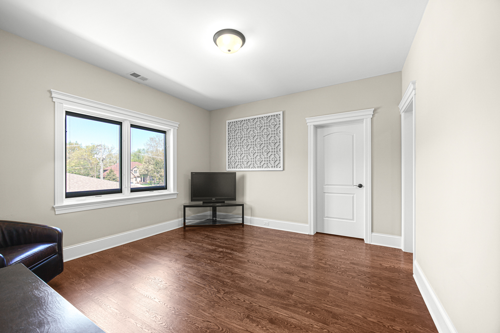 915 Forestview Road Addison, IL 60101 - Photo 23 of 49 a view of room with wooden floor lounge chair and windows