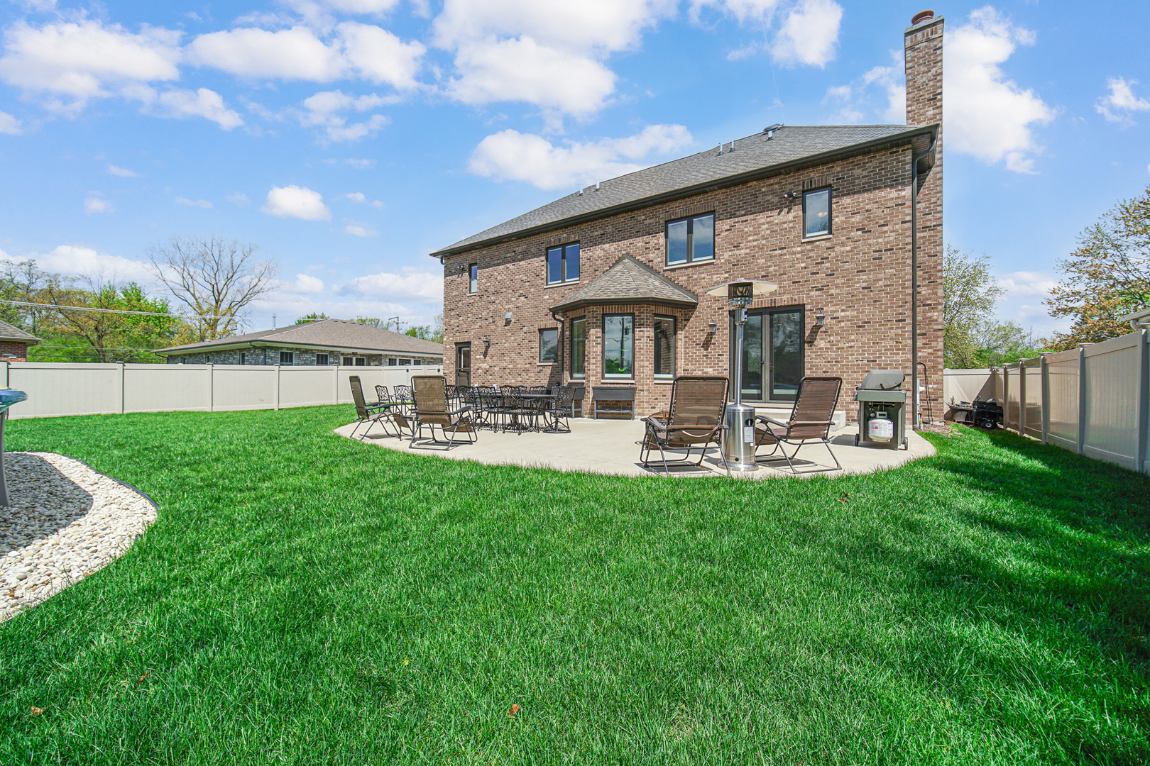915 Forestview Road Addison, IL 60101 - Photo 41 of 49 a view of a patio with table and chairs potted plants and large tree