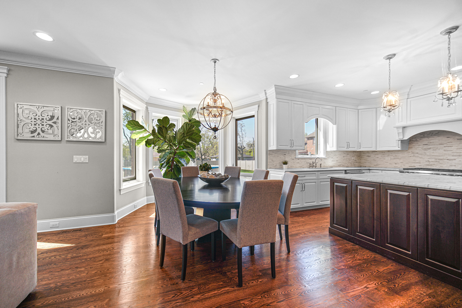 915 Forestview Road Addison, IL 60101 - Photo 9 of 49 a kitchen with granite countertop white cabinets stainless steel appliances dining table and chairs