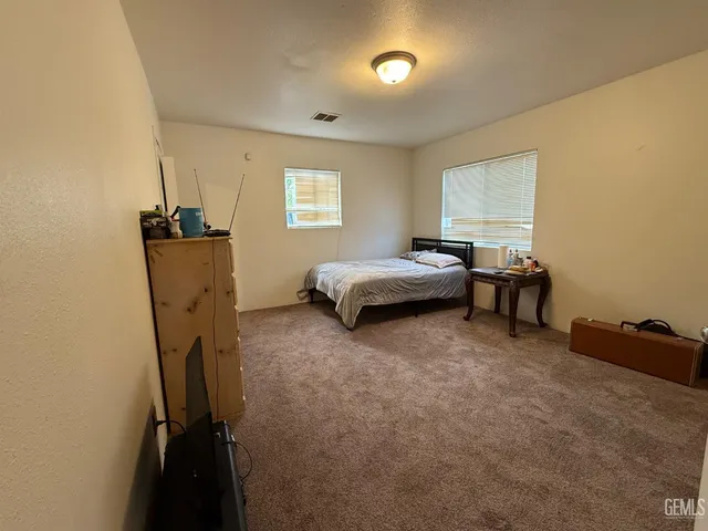 a blue room with wooden floor and furniture