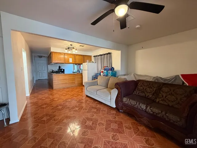 a kitchen with refrigerator a microwave a stove and cabinets
