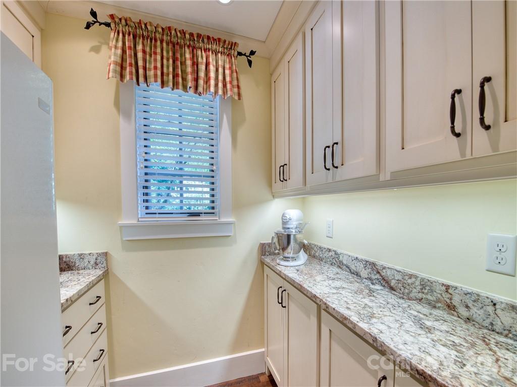 787 East Spark Chaser Road, Unit 16 Sylva, NC 28779 - Photo 22 of 48 a kitchen with a sink and cabinets