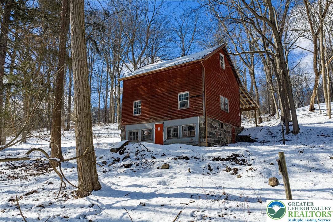 2058 River Road Mount Bethel, PA 18343 - Photo 7 of 39 a view of a house with snow on the road