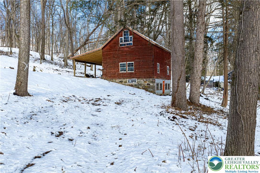 2058 River Road Mount Bethel, PA 18343 - Photo 10 of 39 a front view of a house with a yard covered with snow in front of house