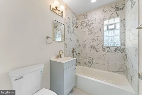 a bath room with a toilet sink and a bathtub