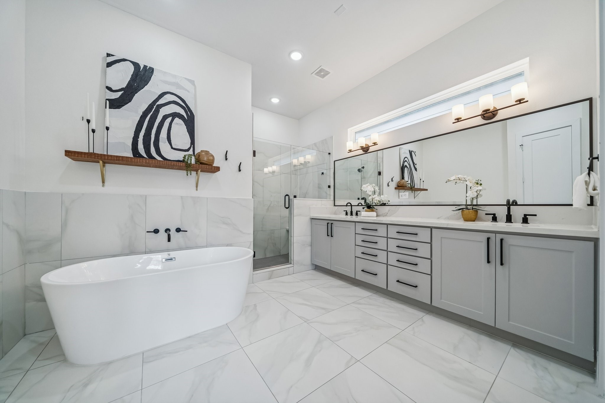 9010 Wellspring Drive Houston, TX 77080 - Photo 13 of 19 a large white bathroom with a sink a bathtub and a mirror