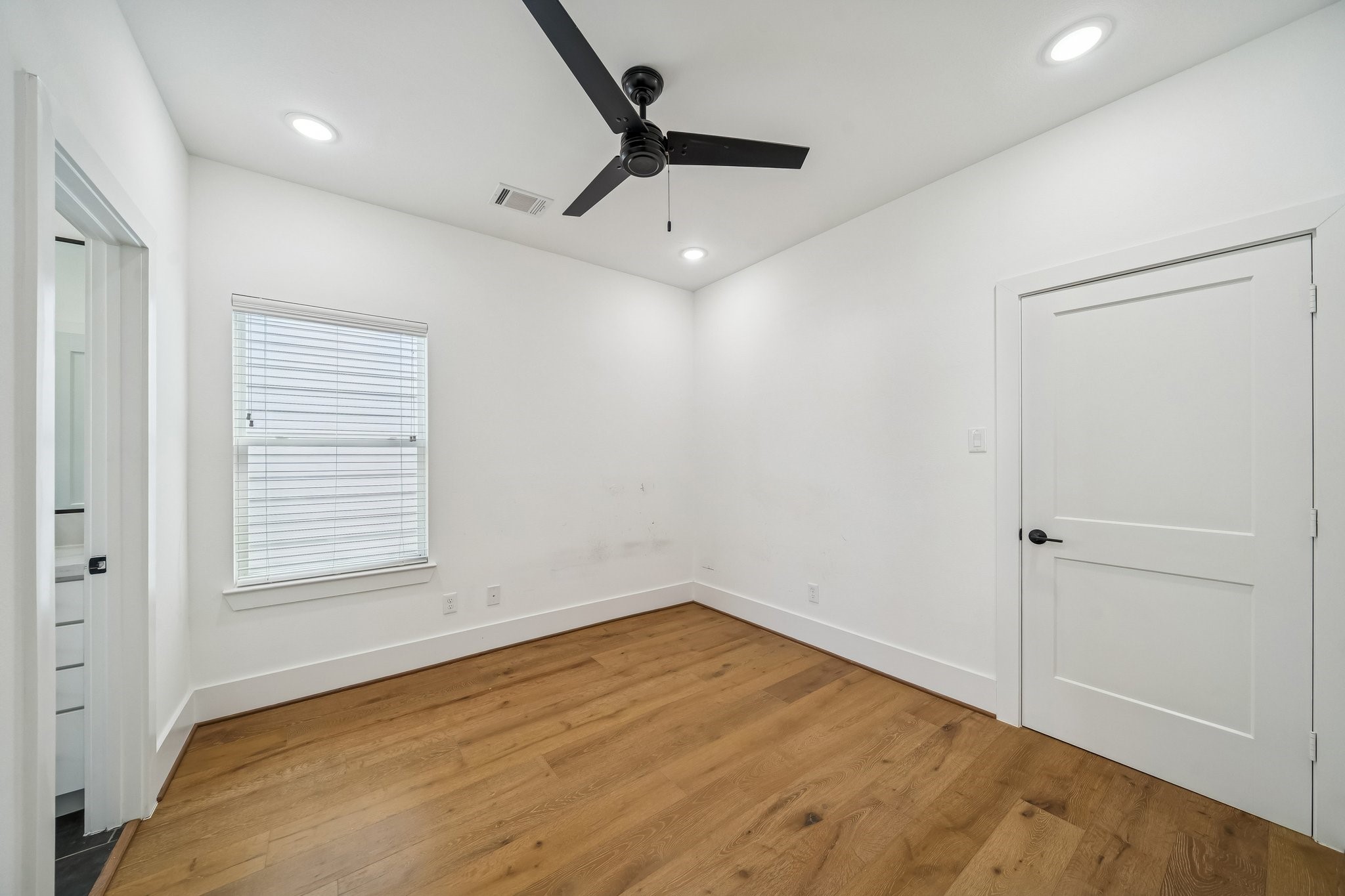 9010 Wellspring Drive Houston, TX 77080 - Photo 14 of 19 wooden floor in an empty room with a window