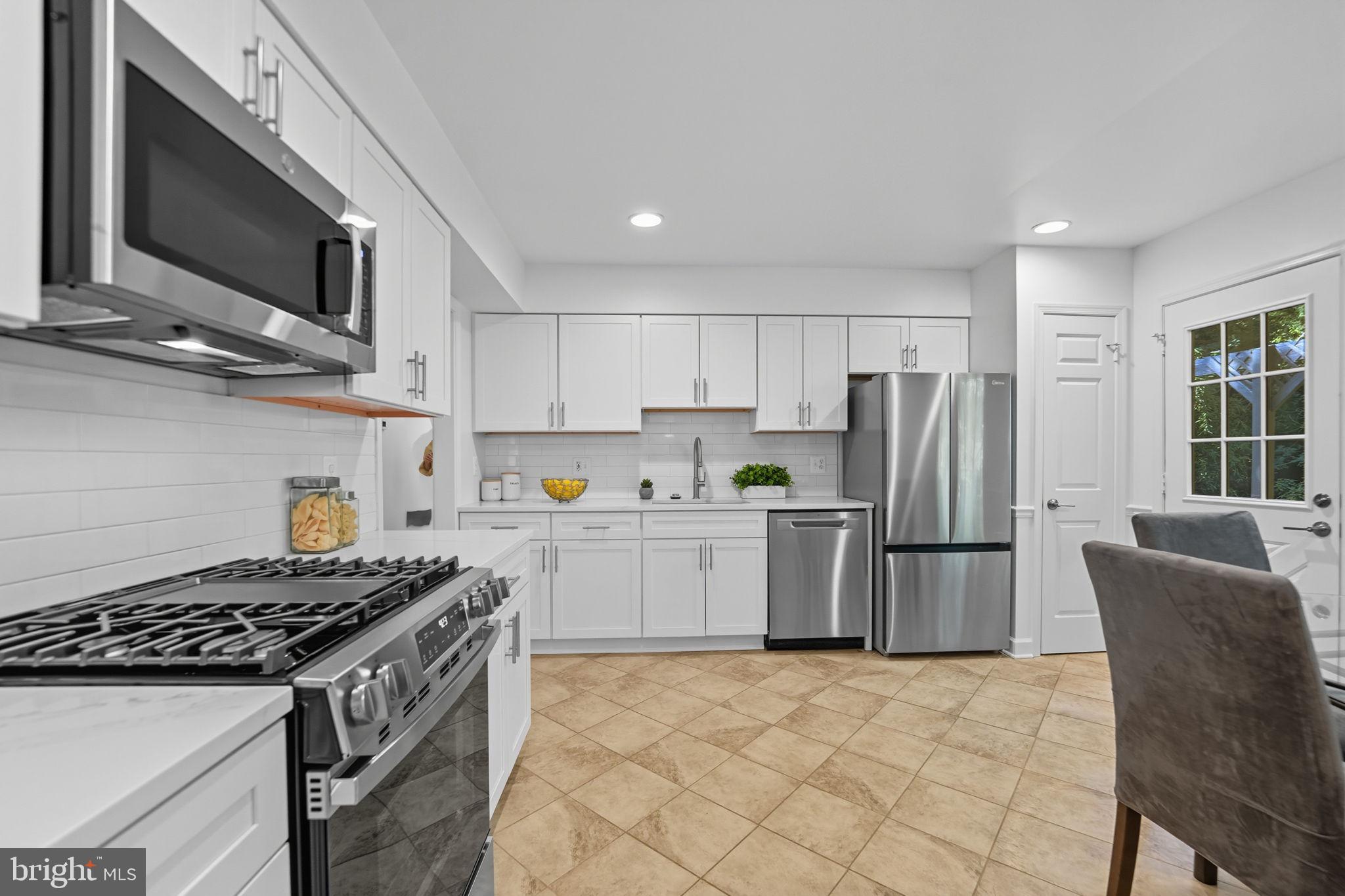 10196 Red Spruce Road Fairfax, VA 22032 - Photo 14 of 36 a kitchen with a stove a microwave and refrigerator