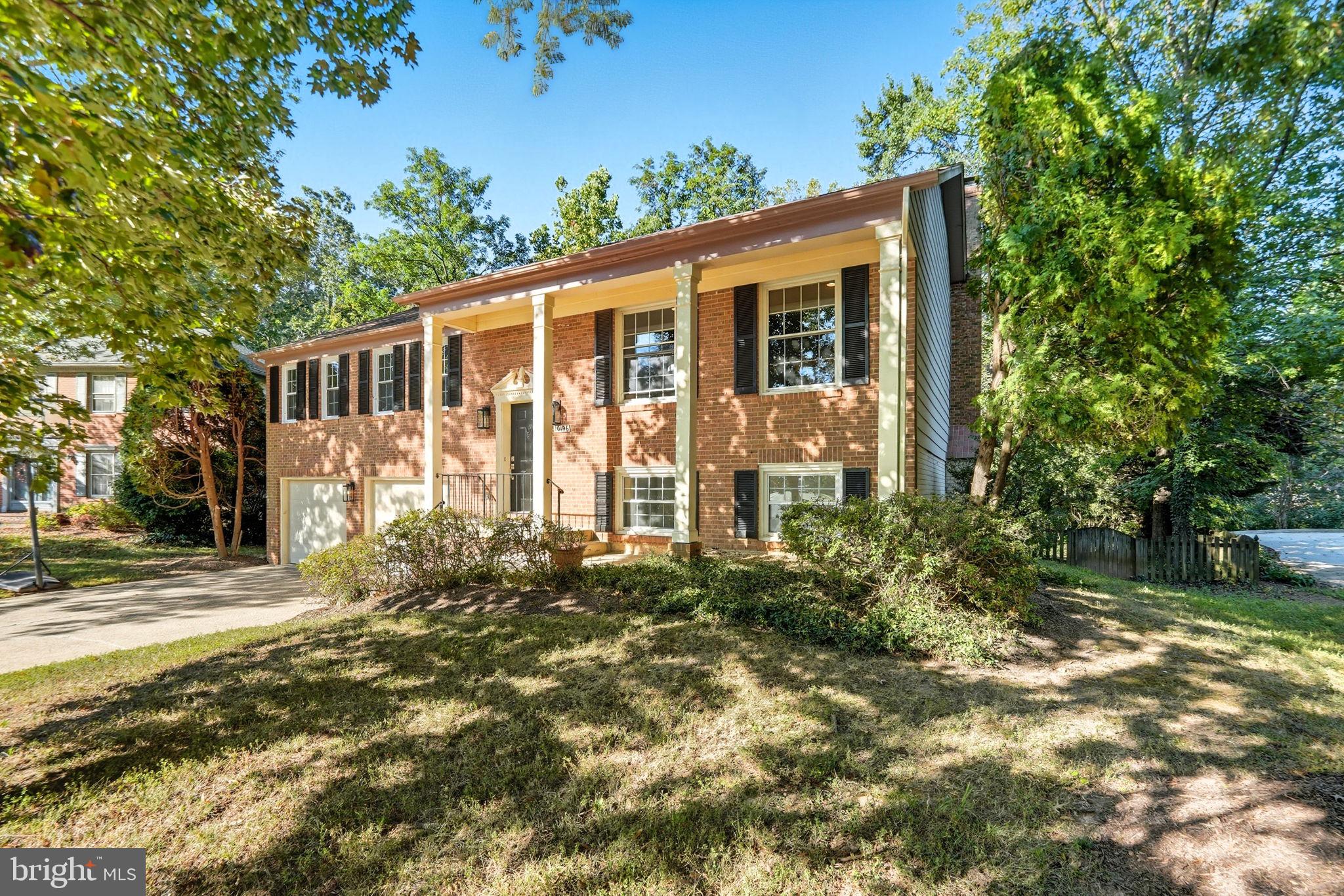10196 Red Spruce Road Fairfax, VA 22032 - Photo 2 of 36 a front view of a house with garden