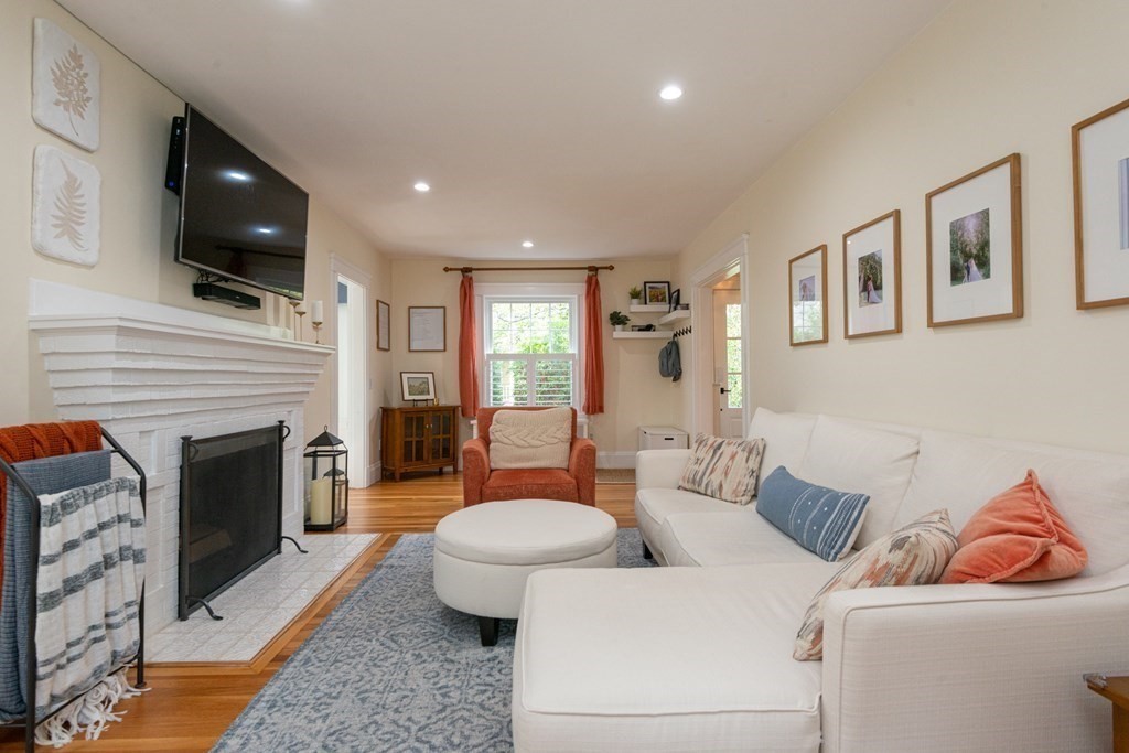 23 Trask Street Danvers, MA 01923 - Photo 19 of 42 a living room with furniture a fireplace and a flat screen tv