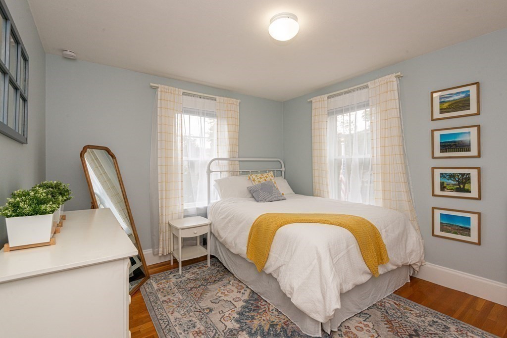 23 Trask Street Danvers, MA 01923 - Photo 30 of 42 a bed sitting in a bedroom next to a window
