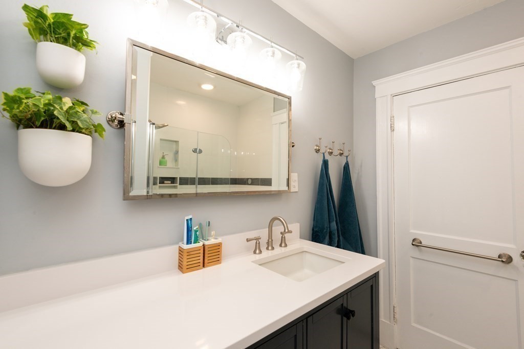 23 Trask Street Danvers, MA 01923 - Photo 35 of 42 a bathroom with a sink vanity and mirror