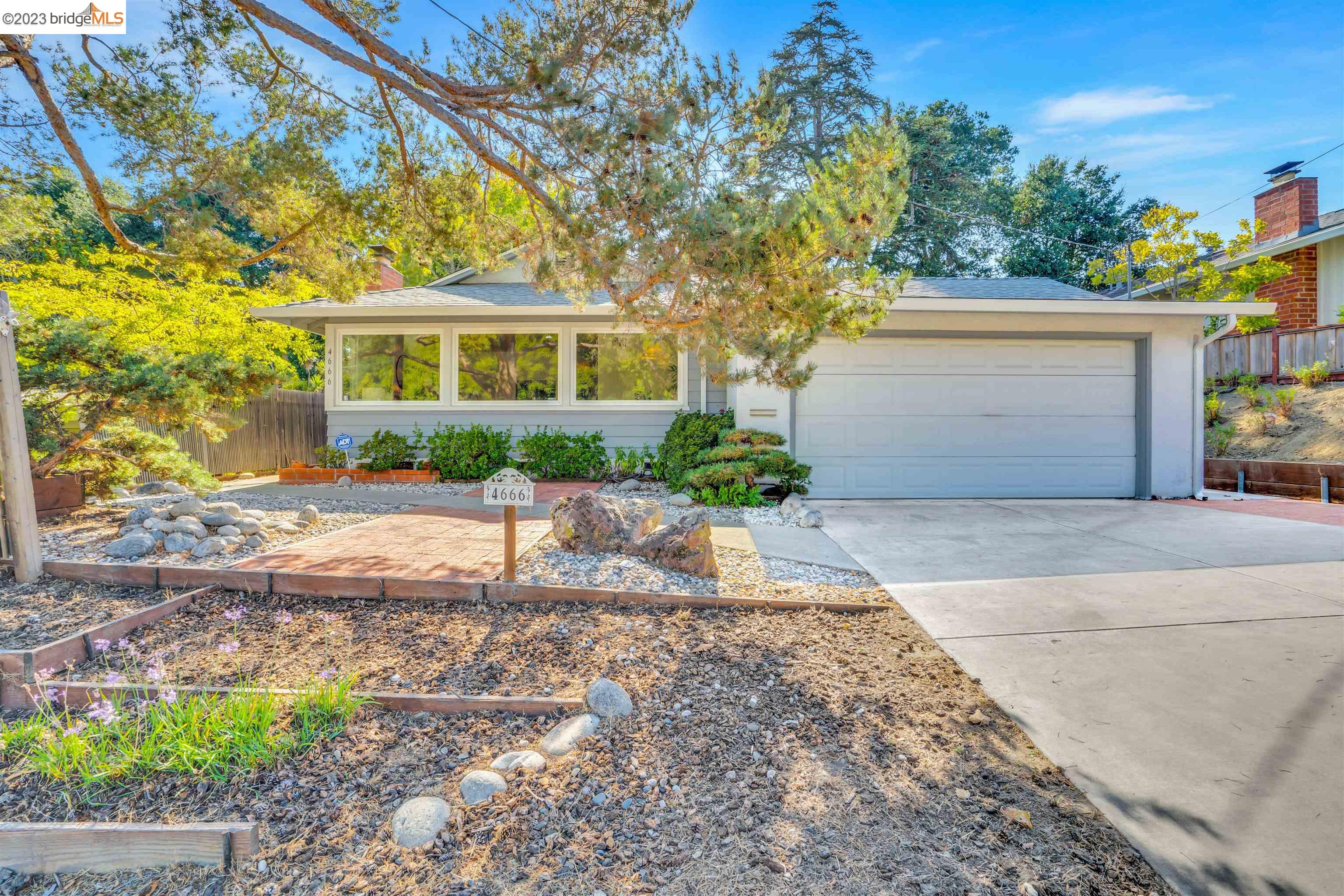a front view of a house with a yard and a garage