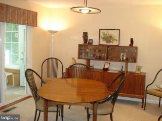 47 Capetown Road Ocean Pines, MD 21811 - Photo 2 of 8 a view of a dining room with furniture and a window