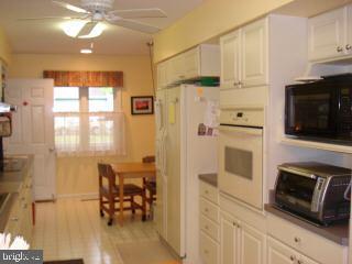 47 Capetown Road Ocean Pines, MD 21811 - Photo 4 of 8 a kitchen with stainless steel appliances a stove a refrigerator and a microwave
