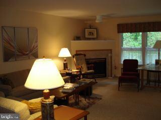 47 Capetown Road Ocean Pines, MD 21811 - Photo 5 of 8 a living room with furniture and a fireplace