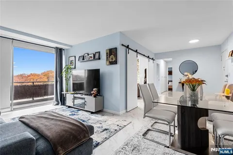 a bedroom with furniture and a large window