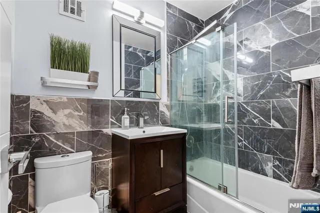 a bathroom with a sink toilet and tub