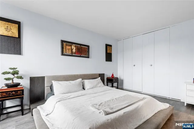 a bedroom with bed and a night stand