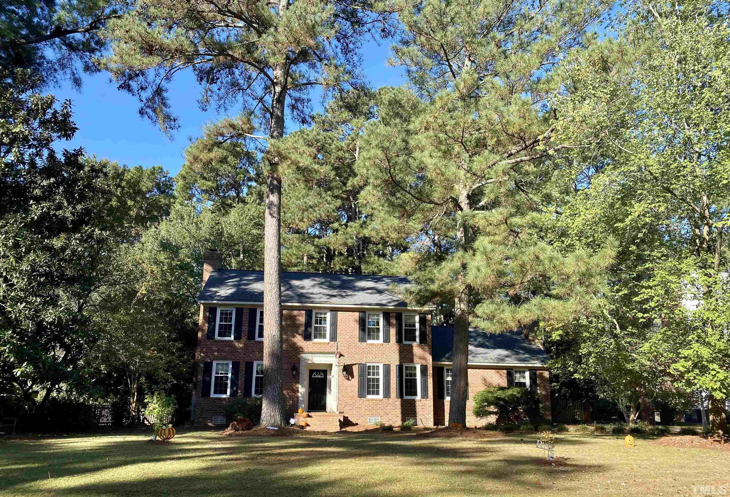2103 Hermitage Road Northwest Wilson, NC 27896 - Photo 1 of 27 a front view of a building with a garden and trees