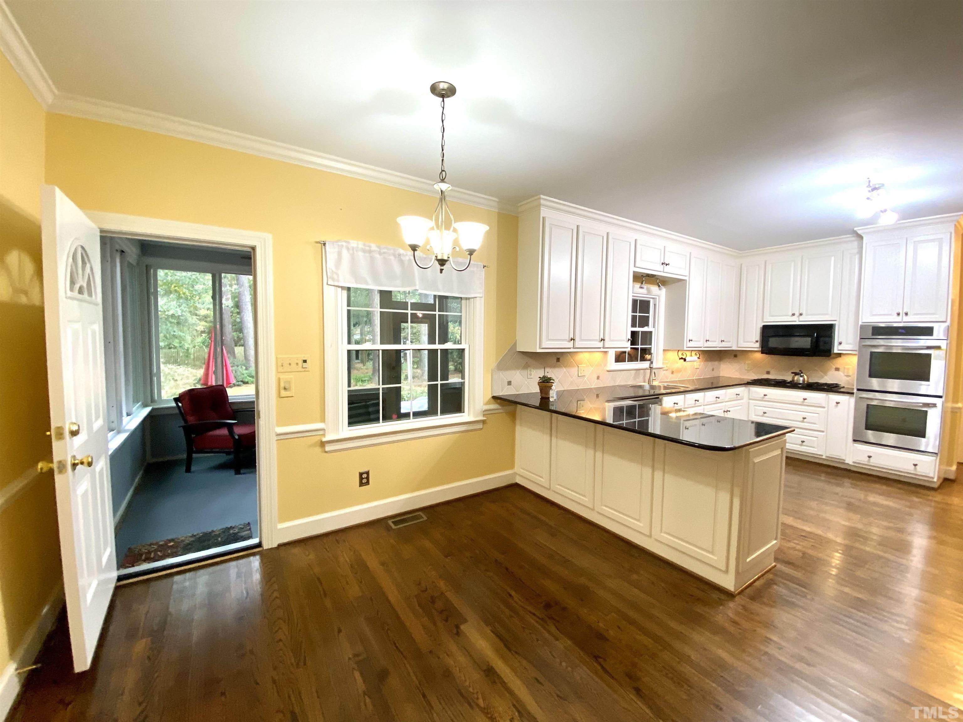 2103 Hermitage Road Northwest Wilson, NC 27896 - Photo 13 of 27 a kitchen with stainless steel appliances granite countertop a stove and cabinets with wooden floors