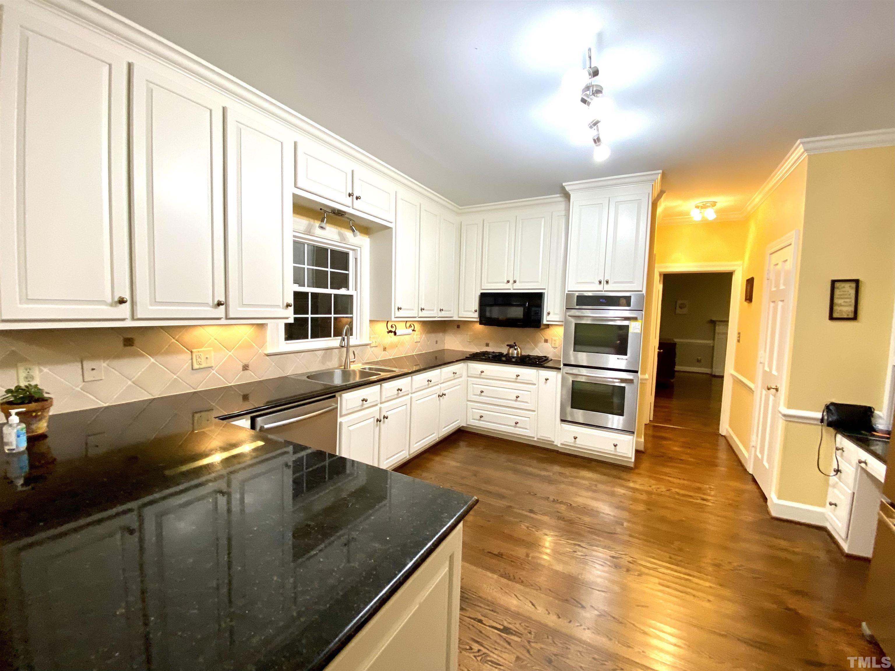 2103 Hermitage Road Northwest Wilson, NC 27896 - Photo 14 of 27 a kitchen with stainless steel appliances granite countertop a sink a stove counter space and cabinets